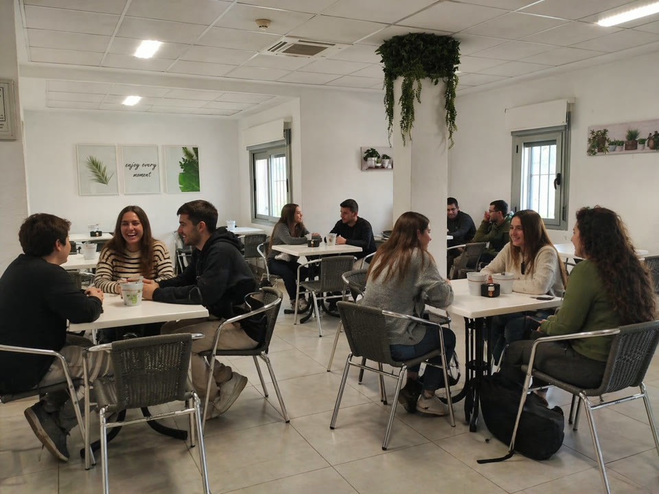 Cafetería del centro formativo con mesas ocupadas por alumnos durante el descanso entre clases.